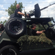 Illustration for article titled Marcin Gortat Rides Humvee With Giant Gun Into His Basketball Camp